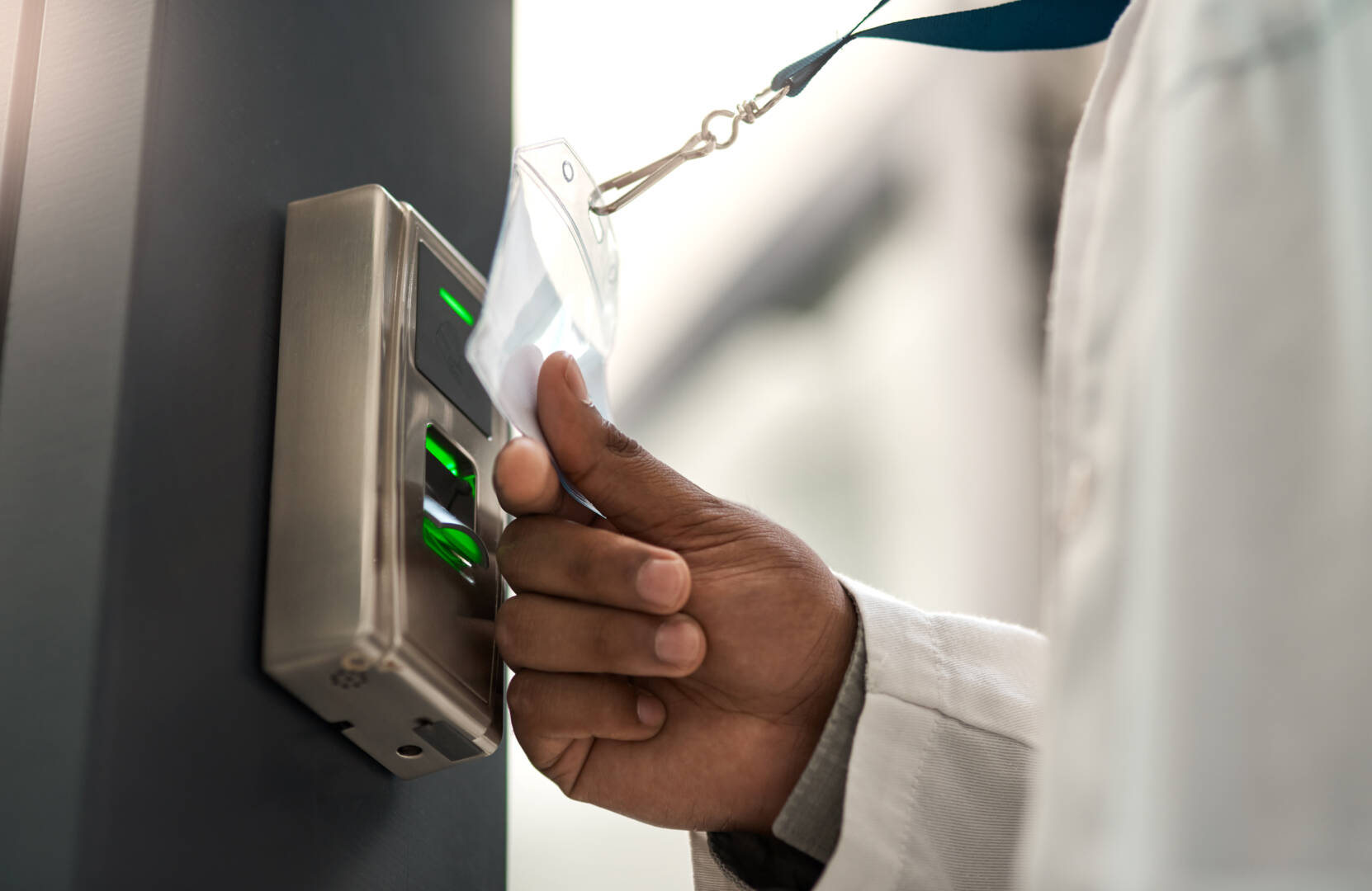 Closeup shot of an unrecognisable scientist using an access card to gain entry at a door.