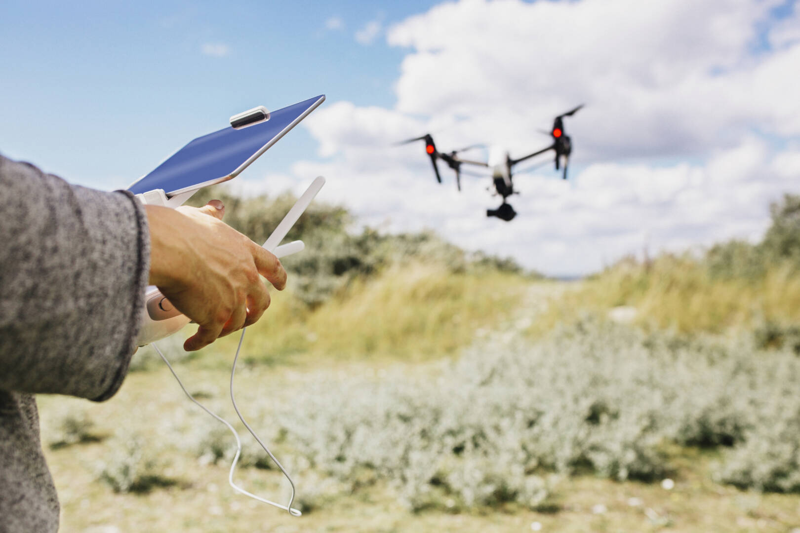 Man flying drone using remote control